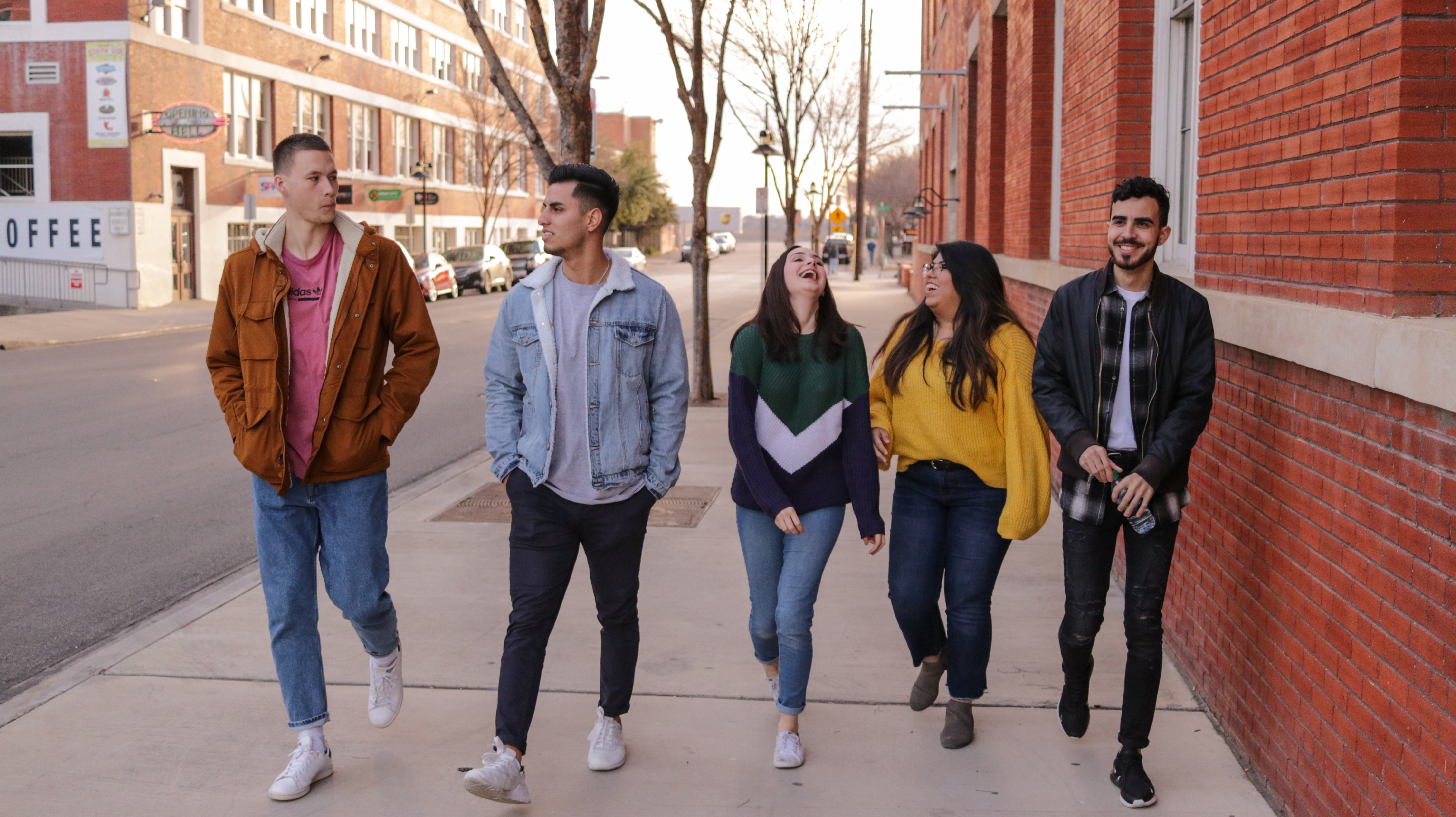 teens walking on sidewalk