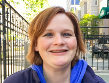 woman with short red hair smiling