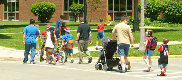 children walking to school on sidewalk